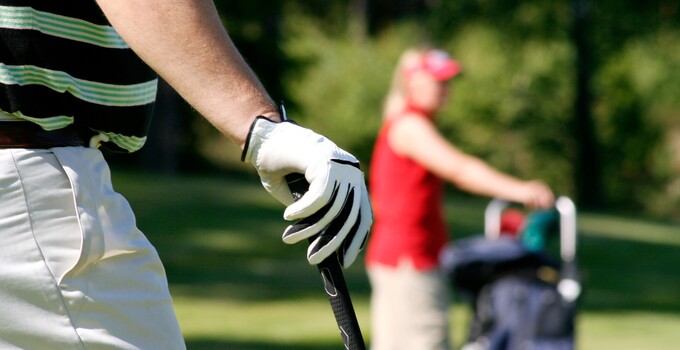 Golf with Two Golfers Holding Club in Fairway Golf with Two Golfers Holding Club in Fairway